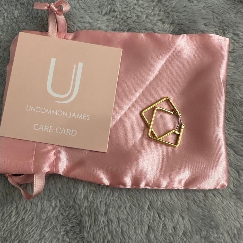 Gently used uncommon James girl boss earrings in gold in a size small